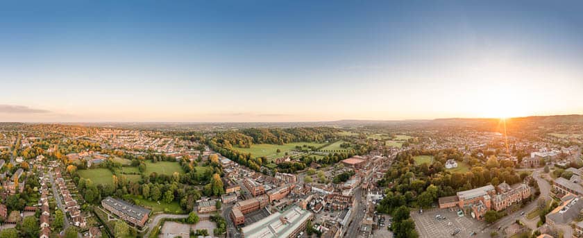 Panoramic Drone view of Reigate Town Centre and Priory Park during sunset.